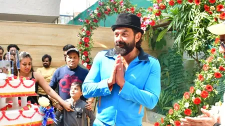 Bobby Deol cuts five-tiered cake with paparazzi, fans offer him huge garland on birthday. Watch videos