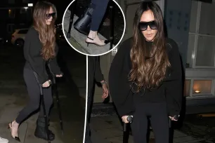 Victoria Beckham hobbles on crutches and one high heel after breaking foot during workout