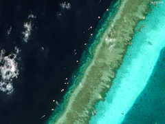 Satellite Images Show Floating Barrier At Disputed South China Sea Reef