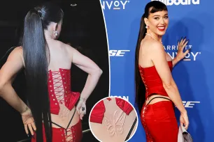 Katy Perry flashes lingerie (and lower back ‘tattoo’) in daring lace-up look at Billboard Women in Music 2024