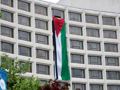 Protesters Hang Huge Palestinian Flag At Venue Of Biden's White House Event