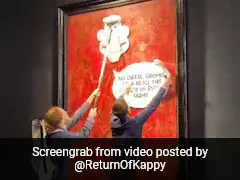 Animal Rights Activists Stick Cartoon Images On King Charles' Portrait