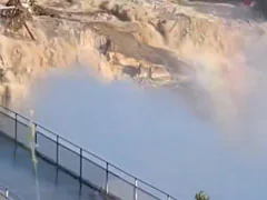 Dramatic Videos Show Raging Water Flowing Around US Dam As It Sweeps Away Building